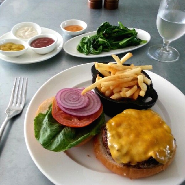 Classic Hamburger with a side of sauteed mustard greens. 