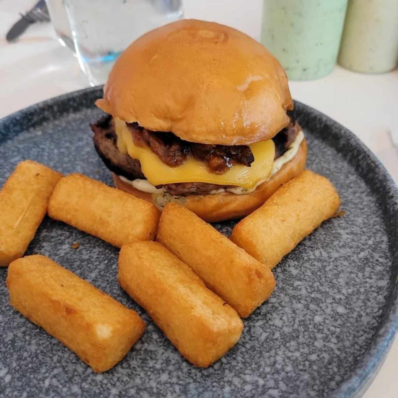 SMOKED PIG LEG BURGER (Cheeseburger with thyme-mayo, American cheese, and smoked pulled pork) with Yuquitas Fritas