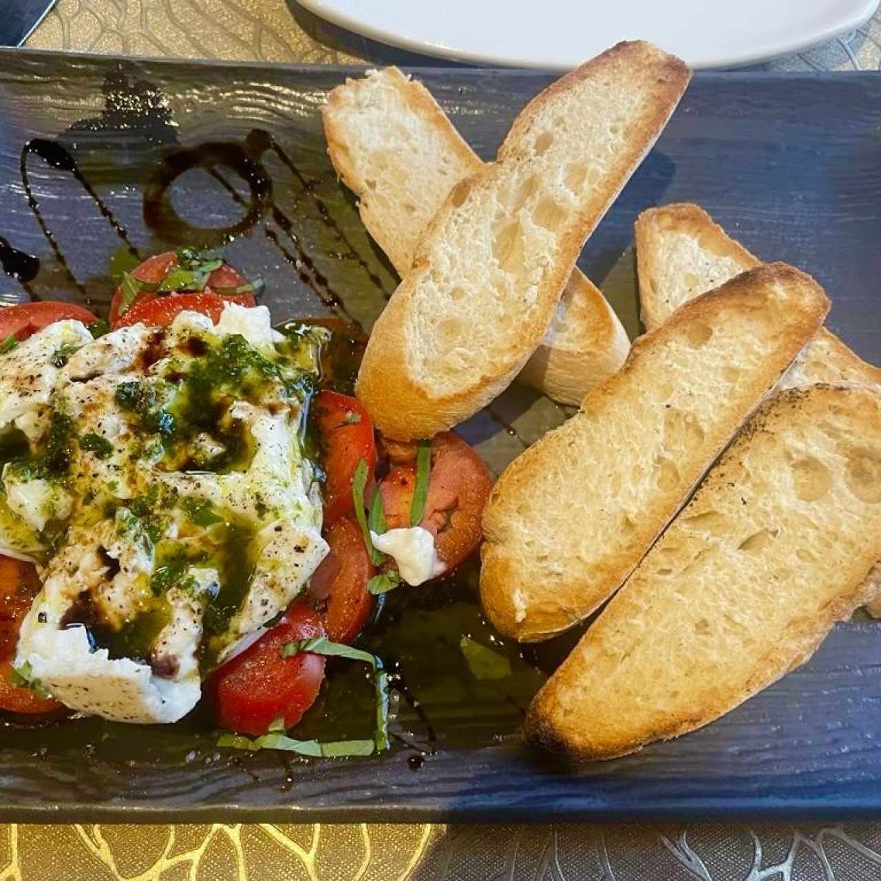 BURRATA DI BUFFALA ASSISI (Burrata de Buffala rellena de Pesto Assisi, Rodajas de Tomate y Rebanadas de Pan Horneado al Instante)