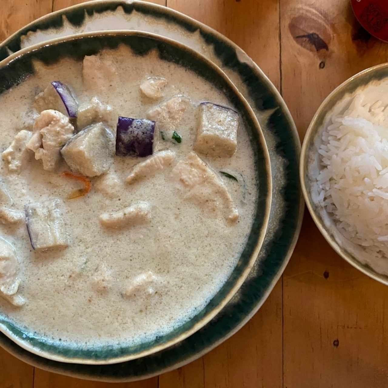 Curry verde cremoso con pollo y vegetales (berenjena) picante al gusto, acompañado con arroz de jazmín. 