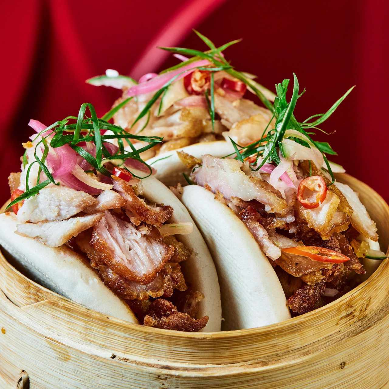 Bao de cerdo ahumado con chicharrón y ensaladilla de sao al estilo panameño, mayonesa de chipotle y encurtido de cebolla