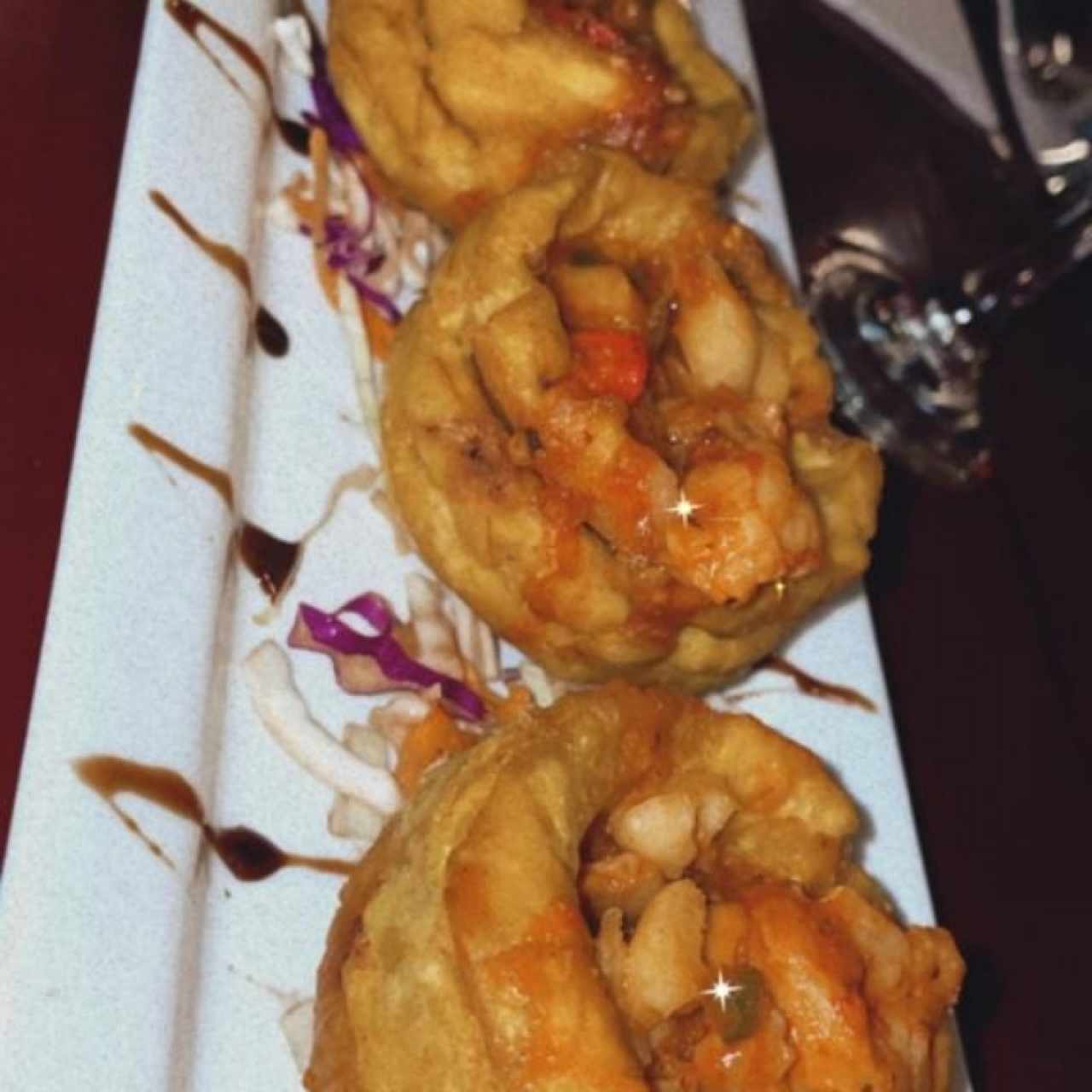 Canasta de patacones rellenos de mariscos en salsa roja