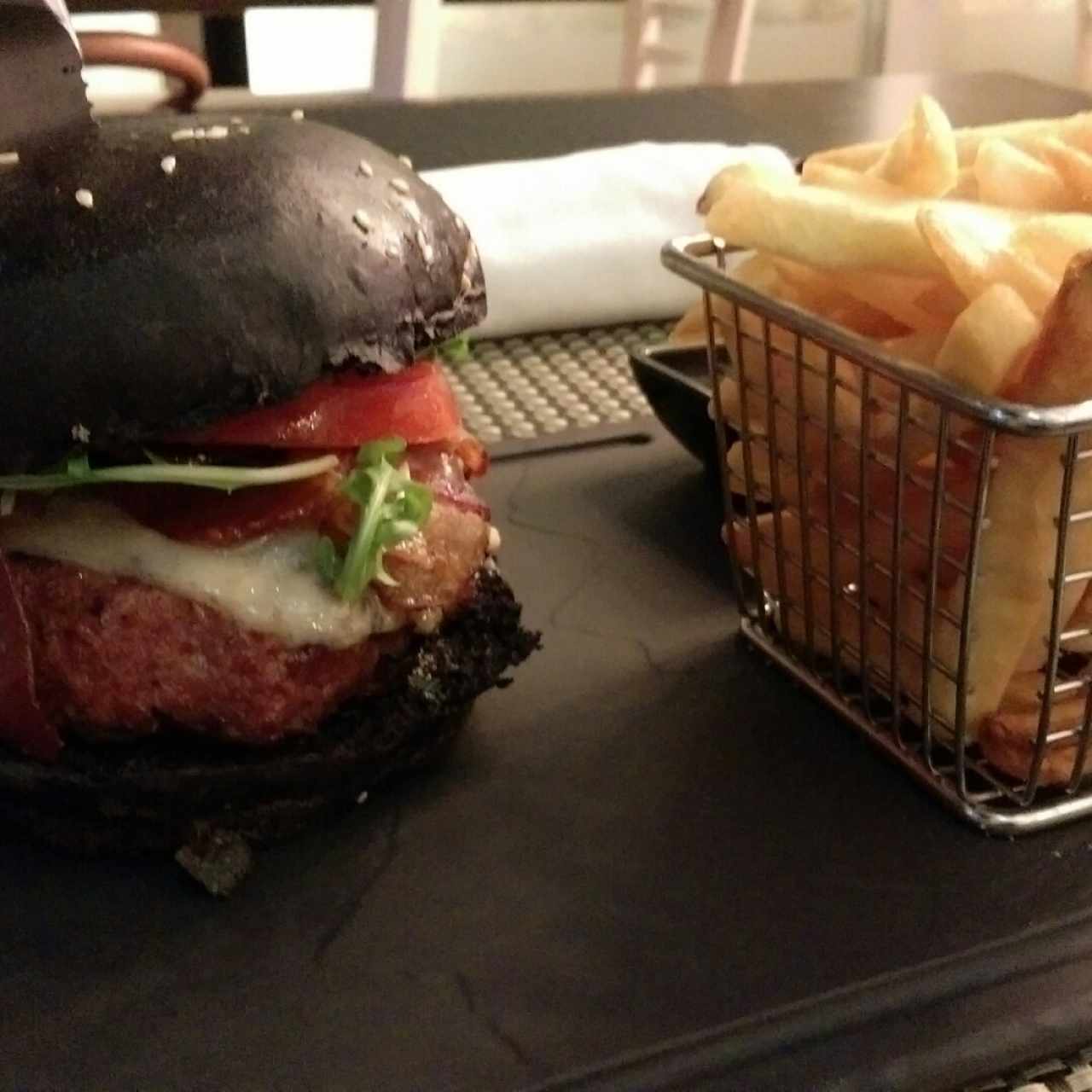 hamburguesa de la casa  carne de res y cerdo en pan exótico negro