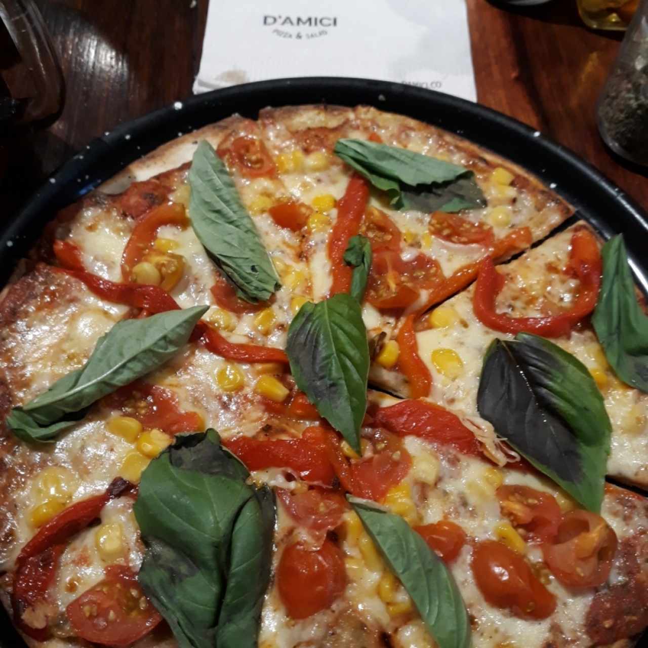 pizza vegana a elección: masa orégano, salsa base tomate y ajo, tomates cherrys, maíz, pimentones asados y albahaca fresca